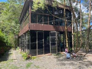 two children are sitting outside of a building at Villa Concepcion Staycation by ngb in Real