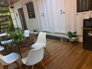 a living room with a table and white chairs at Villa Concepcion Staycation by ngb in Real