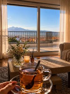 a cup of tea on a table in front of a window at White Ribbon Prizren in Prizren