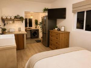 a kitchen with a bed and a sink in a room at Hilton Hideaway in Hilton