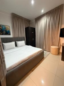 a bedroom with a large bed in front of a window at Abbey's Home in Ogoyo
