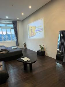 a living room with a bed and a table at MiMo Homestay Đà Lạt in Xuan An +21 photos