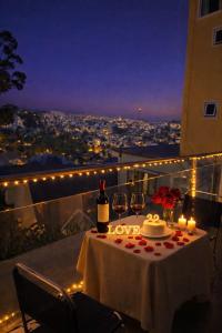 a table with a bottle of wine and a cake and candles at MiMo Homestay Đà Lạt in Xuan An