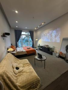 a bedroom with two beds and a large window at MiMo Homestay Đà Lạt in Xuan An