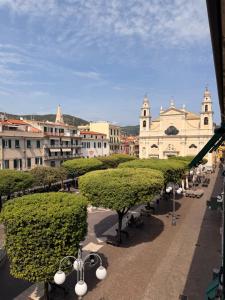 a view of a city with trees and buildings at Hotel Miramare in Pietra Ligure