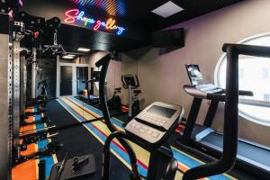 a gym with treadles and a treadmill at Hotel Polonez in Krakow