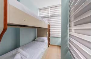 a small bedroom with a bunk bed in it at Lika's Residence in Golem