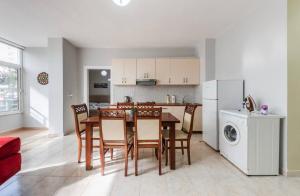 a kitchen and dining room with a table and chairs at Lika's Residence in Golem