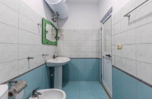 a bathroom with a sink and a toilet and a mirror at Lika's Residence in Golem +5 photos