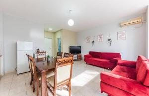 a living room with a red couch and a table at Lika's Residence in Golem