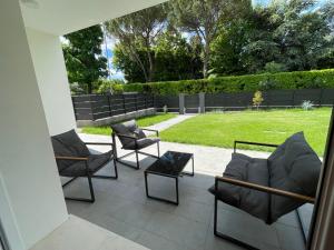 a patio with two chairs and a table at Casa Valeria in Abano Terme