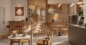 a restaurant with tables and chairs and a bar at De Herbert Amsterdam - Formerly France Hotel in Amsterdam