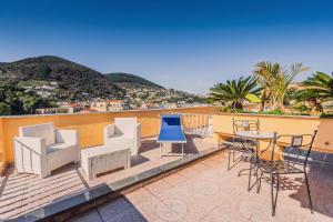 a balcony with chairs and a table with a view at Aragona Palace Hotel & Spa in Ischia Town