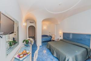a bedroom with a bed and a table with food on it at Aragona Palace Hotel & Spa in Ischia Town