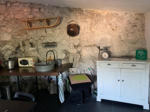 a kitchen with a counter and a table and a counter top at Il giardino di Lallo in Barrea +12 photos