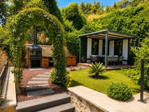 a garden with an outdoor kitchen and a gazebo at Villa Yagmur in Kalkan