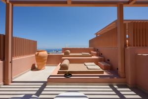 two beds on a balcony with the ocean in the background at Thianne Luxury Suites in Fira