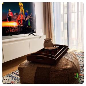 a living room with a tv and a couch at The Quiet Creative, Corporate-Ready 1BR in Tatu City