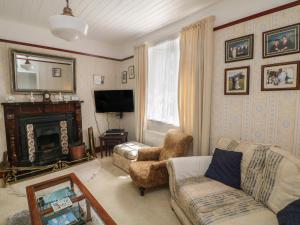 a living room with a couch and a fireplace at Cairbre House in Dungarvan