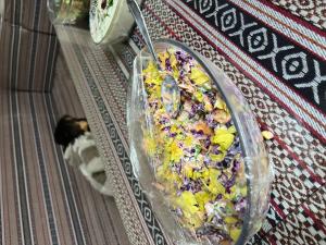 a salad in a plastic container on the floor at Magic rum hussen Luxury in Wadi Rum +18 photos