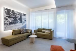 a living room with two couches and a table at Velino Business Suite in Avezzano