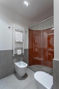 a bathroom with a toilet and a sink and a shower at Velino Business Suite in Avezzano