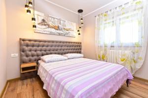 a bedroom with a large bed and a window at House Pavicini 333 in Pavicini +28 photos