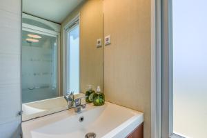 a bathroom with a sink and a mirror at Location Mobile home in Marseillan +16 photos