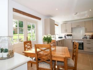 a kitchen with a wooden dining room table and chairs at 5 Shrewsbury Road in Much Wenlock