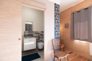 a bathroom with a sink and a toilet in a room at Les Brimbelles in Brû