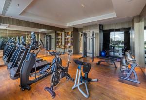 a gym with several treadmills and cardio machines at Vivanta Vrindavan in Vrindāvan +69 photos