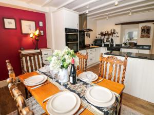 a kitchen with a table with plates on it at Bargate Cottage in Castleton