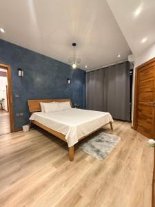 a bedroom with a bed and a blue wall at VLAP Residence in Baie du Tombeau +91 photos
