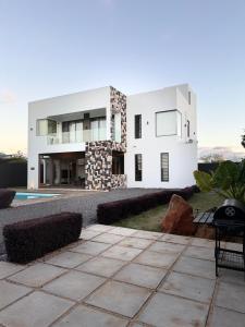 a large white house with a swimming pool at VLAP Residence in Baie du Tombeau