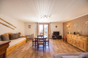 a living room with a couch and a table at L'Edelweiss - Bouvier in Aillon-le-Jeune