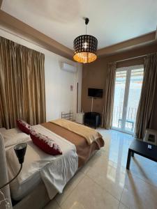 a bedroom with a large bed and a chandelier at Terrazza Partenopea in Naples