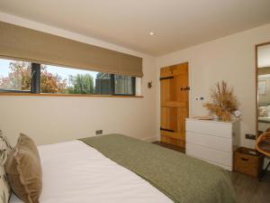 a bedroom with a large bed and a window at Thyme Away in Bucknell