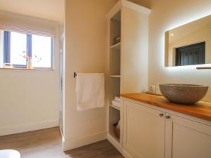 a bathroom with a sink and a mirror at Thyme Away in Bucknell +38 photos