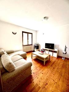 a living room with a couch and a coffee table at Casa Furlan in Calalzo