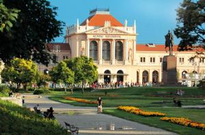 a large building with a statue in front of it at City Centre Dream place in Zagreb