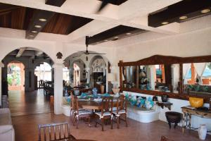 a living room with a table and chairs and a couch at M Villa’s Farm Resort in Romblon