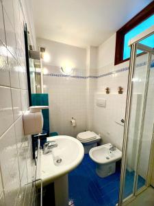 a bathroom with a sink and a toilet at Casa Furlan in Calalzo +7 photos