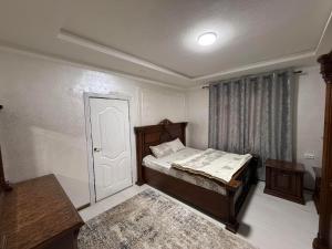 a small bedroom with a bed and a door at Apartment Registon in Samarkand +12 photos