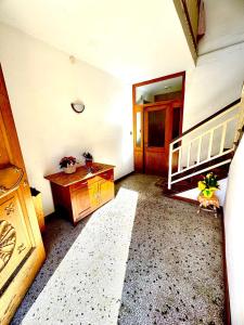 a room with a wooden table and a wooden door at Casa Furlan in Calalzo