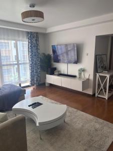 a living room with a couch and a table at Cytonn unique suits in Ruaka