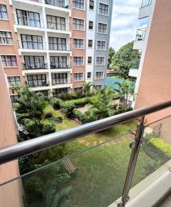a balcony with a view of a building at Cytonn unique suits in Ruaka