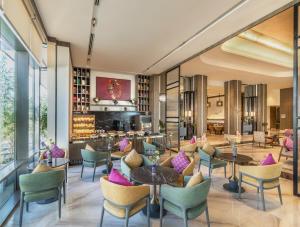 a lobby with tables and chairs and a bar at Vivanta Vrindavan in Vrindāvan
