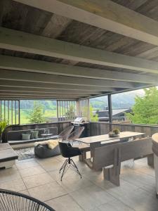 a living room with a large wooden table and chairs at GOING TRIPLE A apartments NORTH in Going am Wilden Kaiser