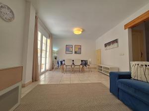 a living room with a blue couch and a table at Las Casitas de la Playa in Vera