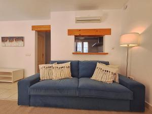 a blue couch in a living room at Las Casitas de la Playa in Vera